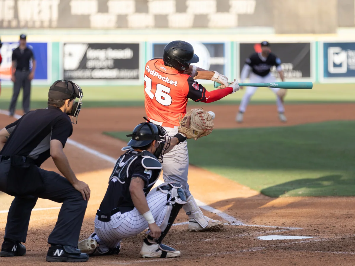 A runner slides into home plate at Blair Field as the catcher takes the throw