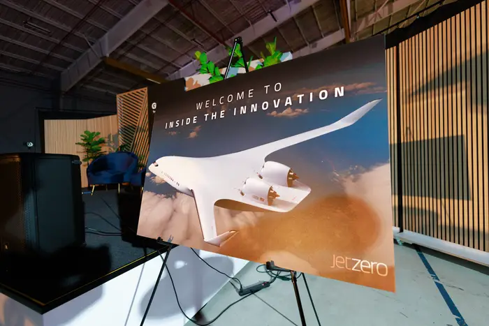 A screen reading welcome to the innovation, with the JetZero blended-wing aircraft on it