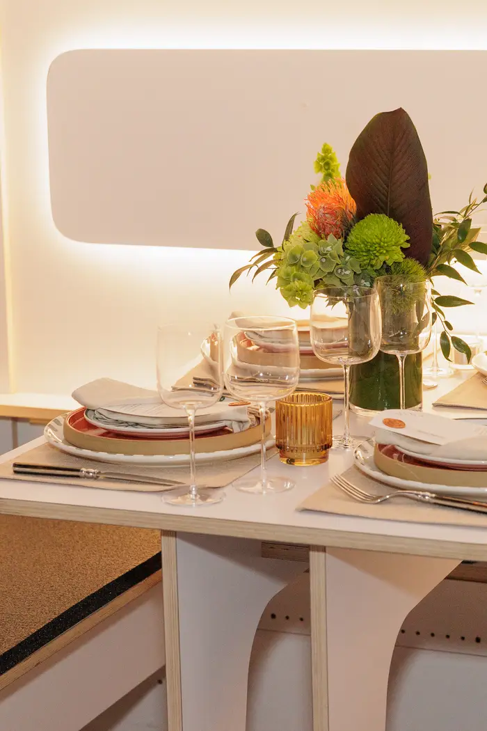 A single setting photographed down the length of the cabin table