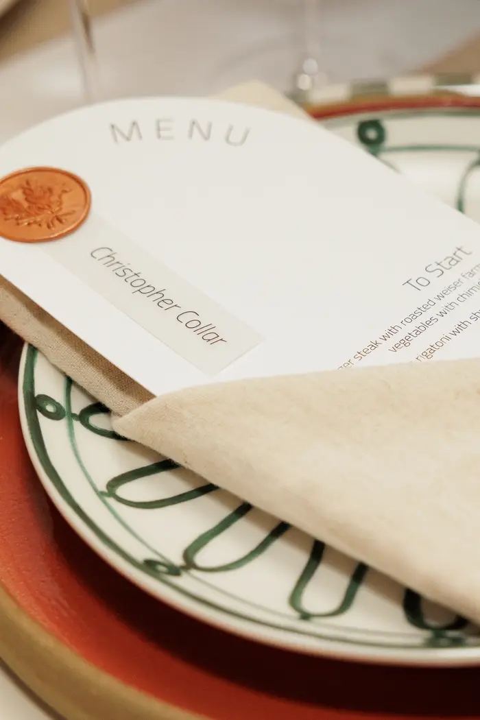 The printed menu resting on a charger plate