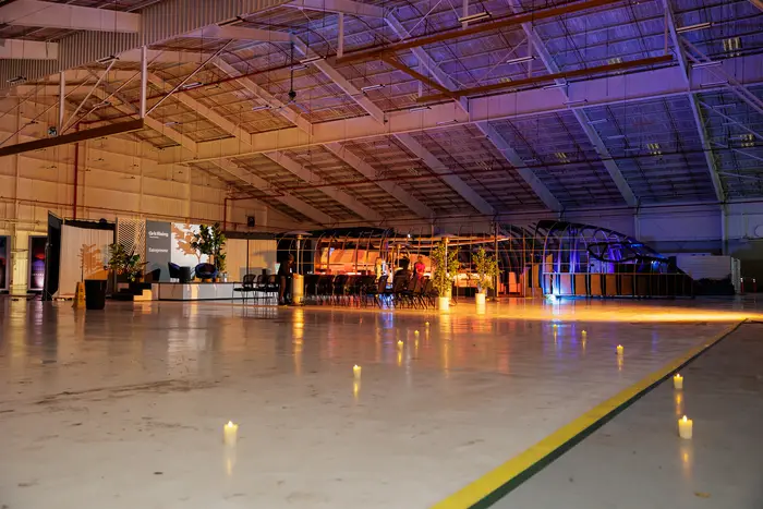 The last of the room, banner panels still lit down the empty floor