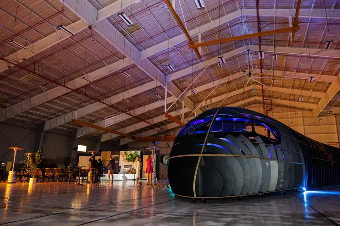The mockup from the side, light raking across its moulded shell