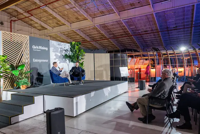 The hangar floor packed with seated guests facing the stage