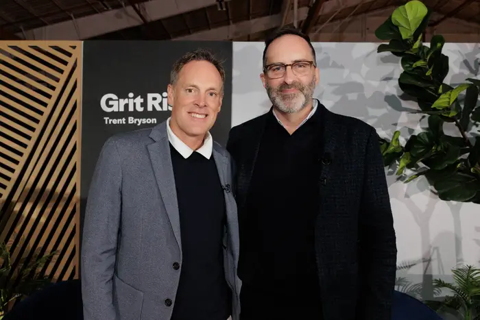 Two guests photographed together at the backdrop
