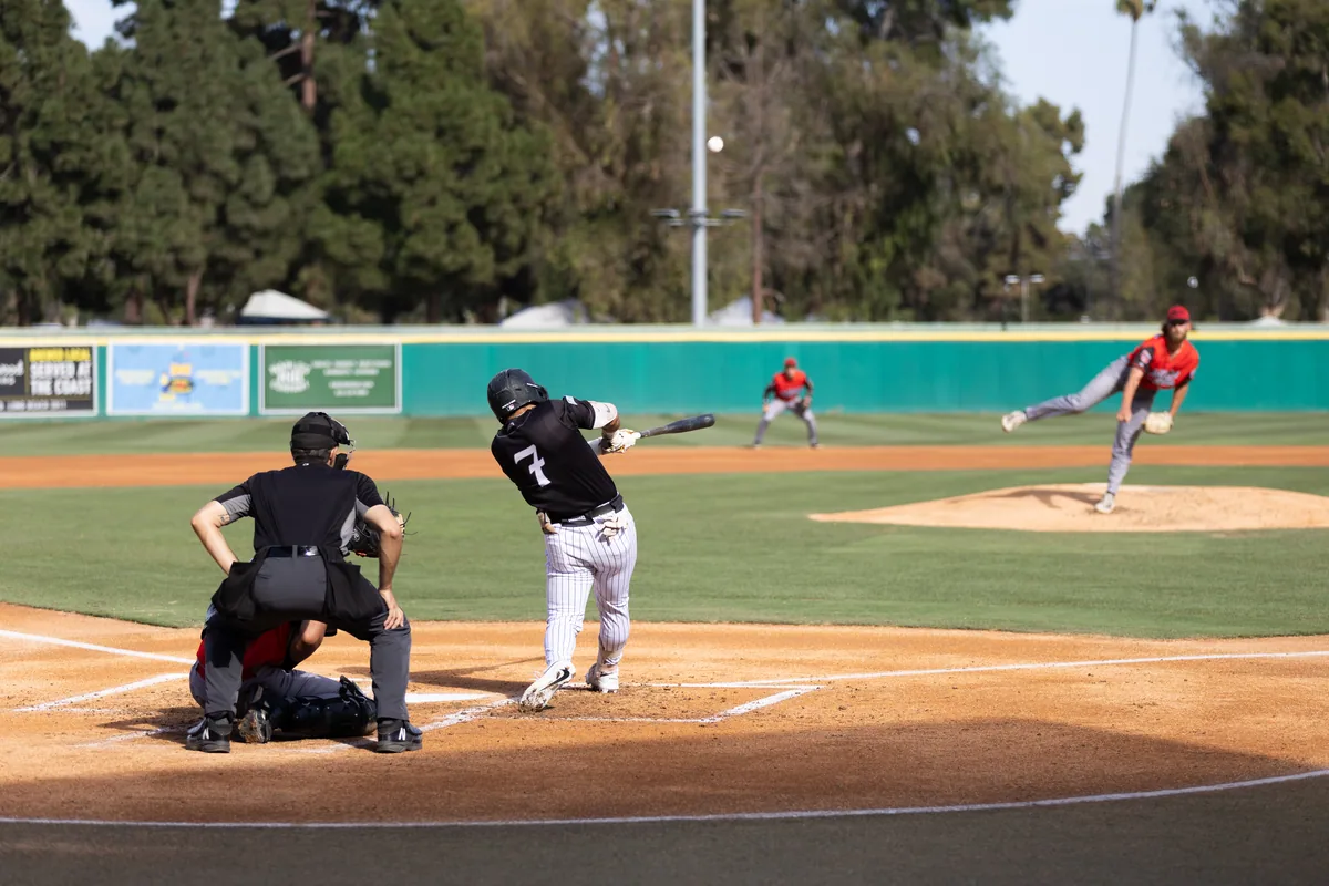 A swing and the ball off the bat down the third base line