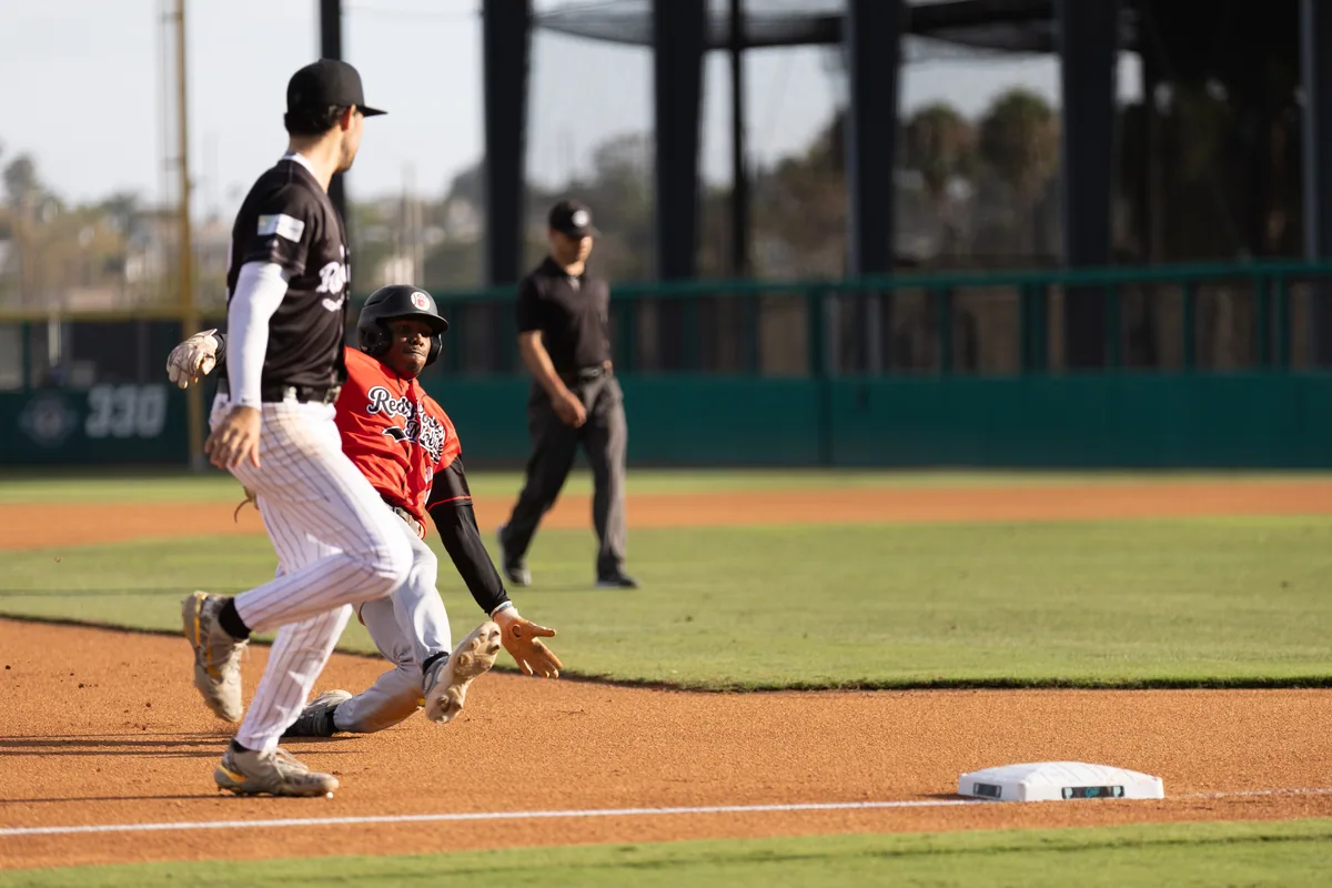 An infielder fields and turns toward the bag