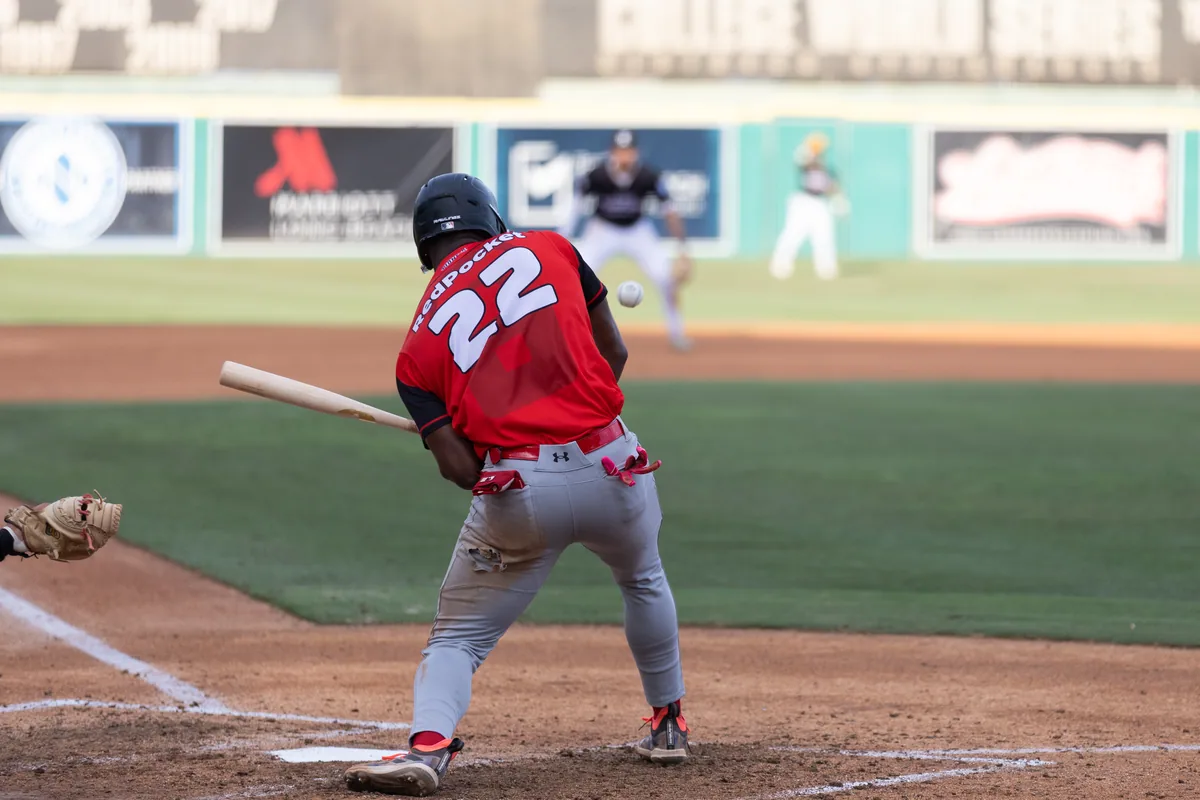 Catcher and batter in the dust after a swing