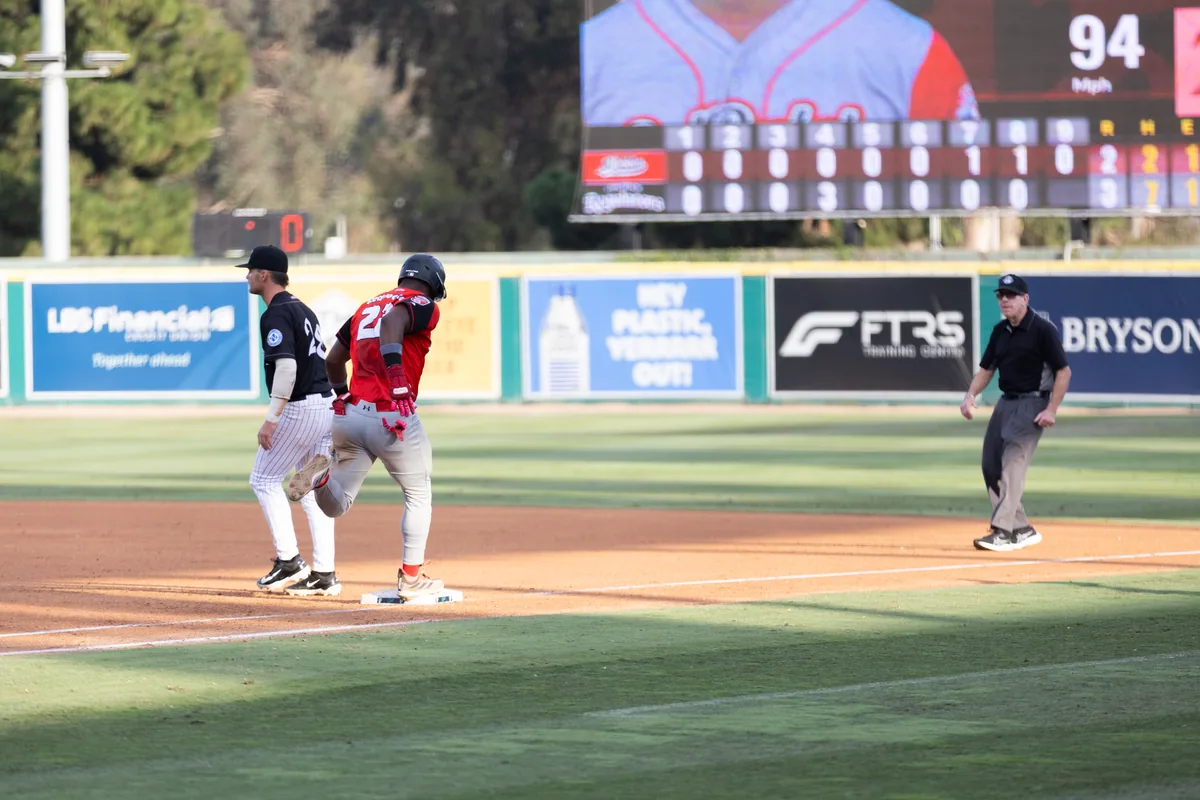 The scoreboard and outfield boards seen across the diamond