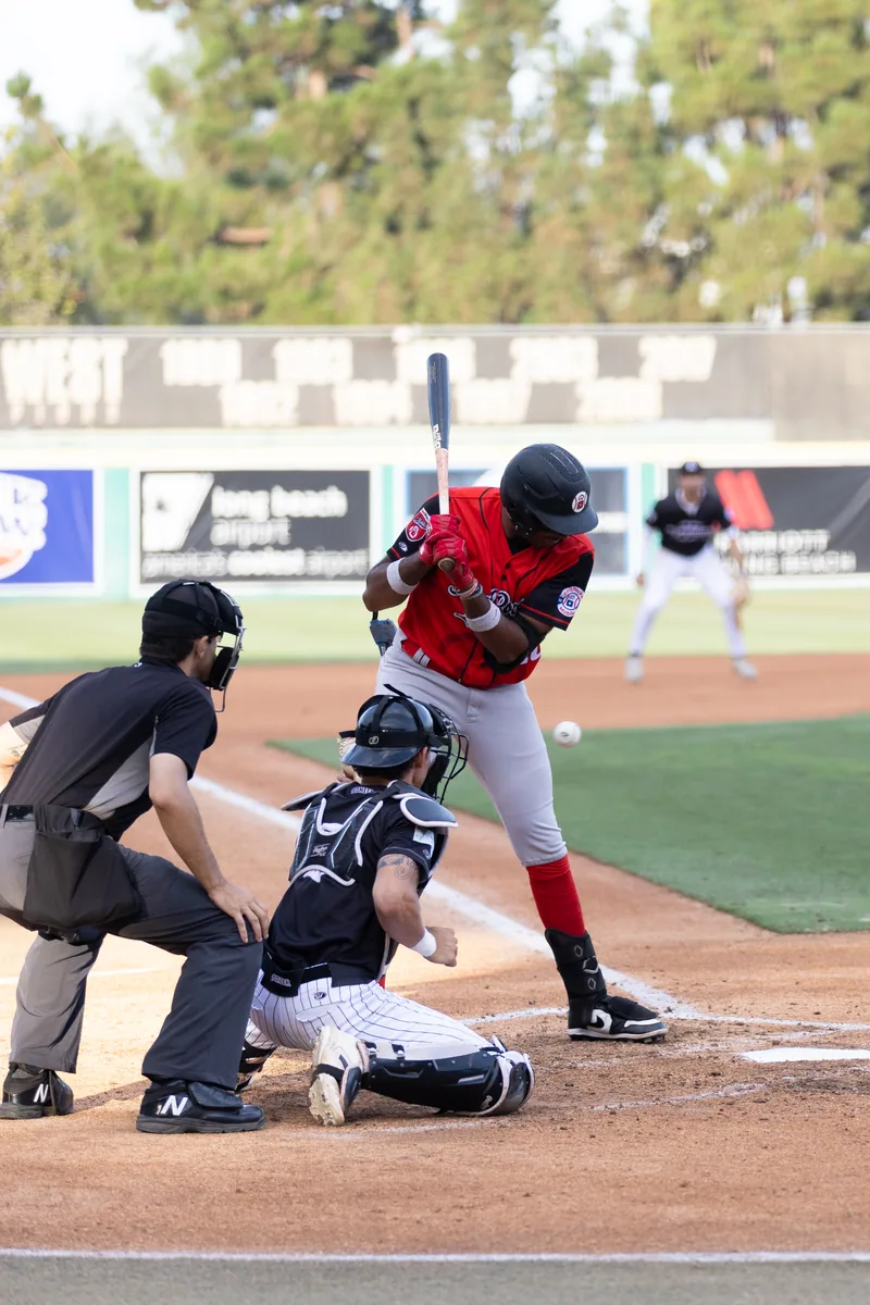 A catcher framed tight behind the plate, mask on
