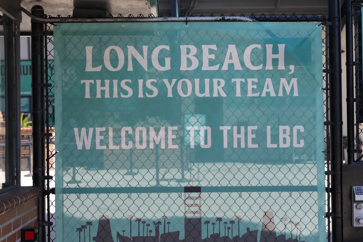 The outfield sign reading Long Beach, this is your team — welcome to the LBC