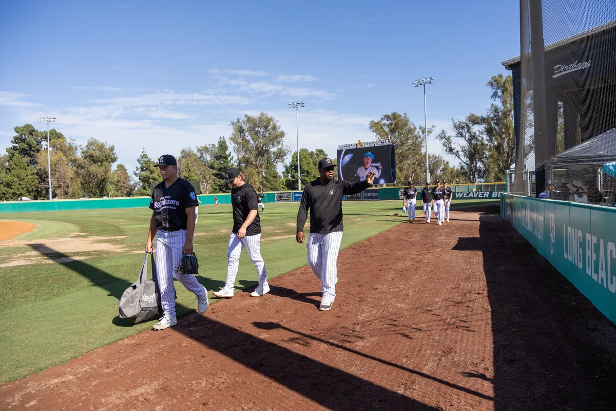 Coaches talking on the mound during warm-ups