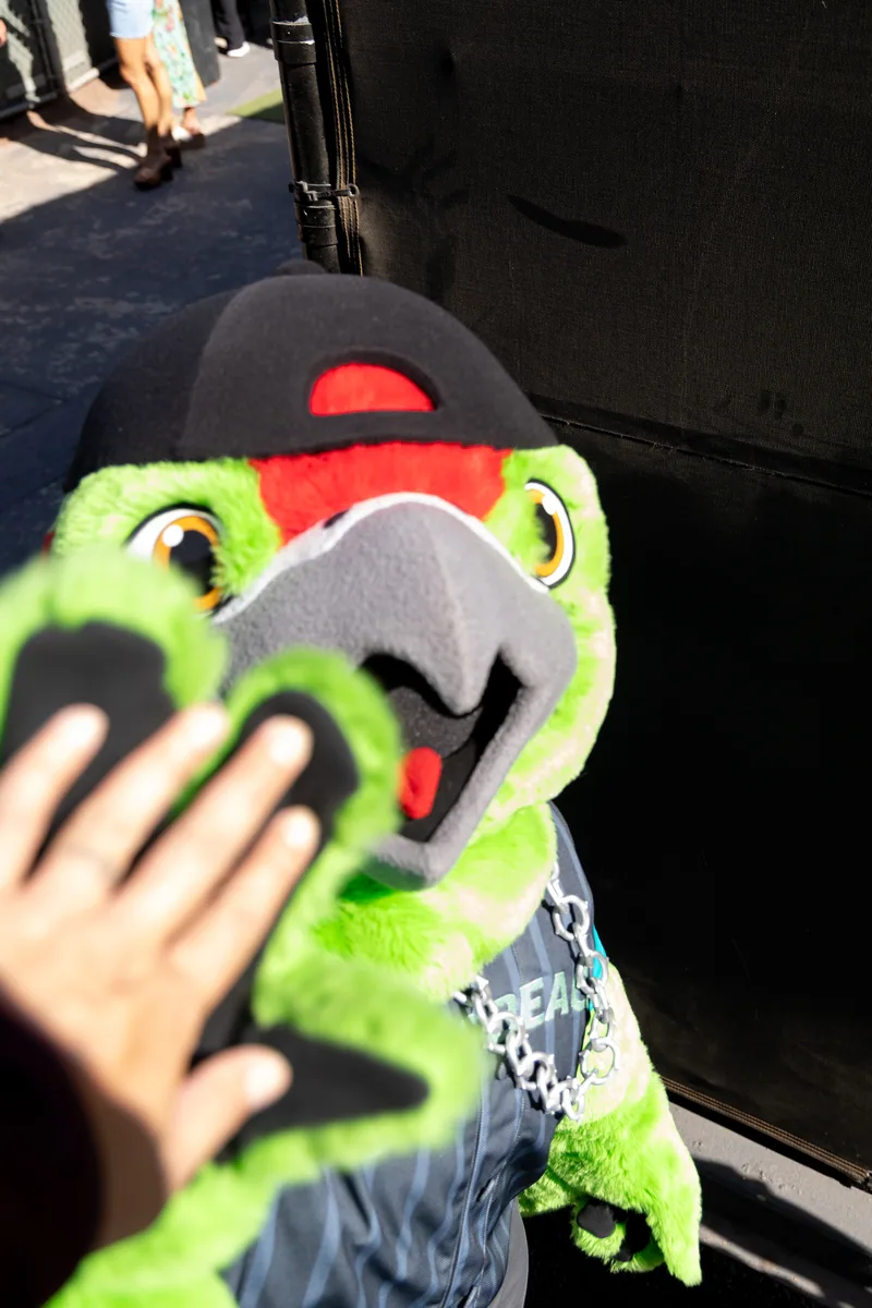 The mascot close up, a small hand on its beak