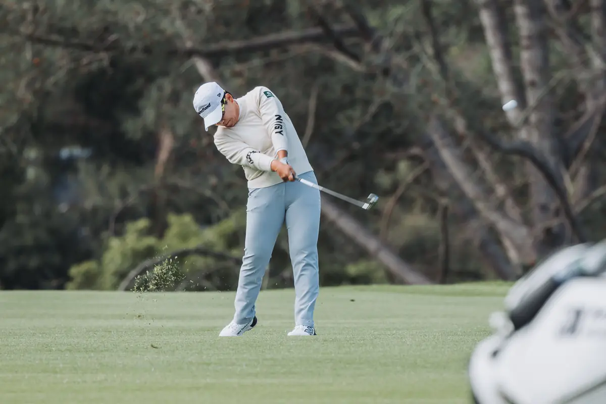 An iron shot caught exactly at impact, turf lifting off the face at Palos Verdes Golf Club