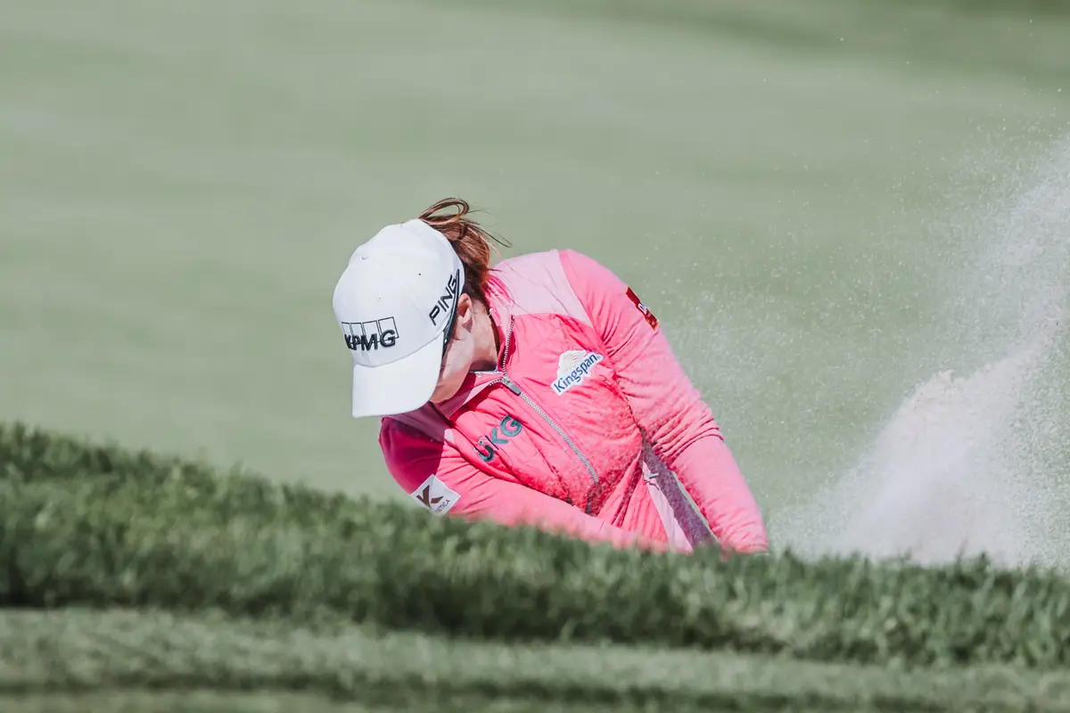Sand exploding from a greenside bunker at Palos Verdes Golf Club as the player drives the club through