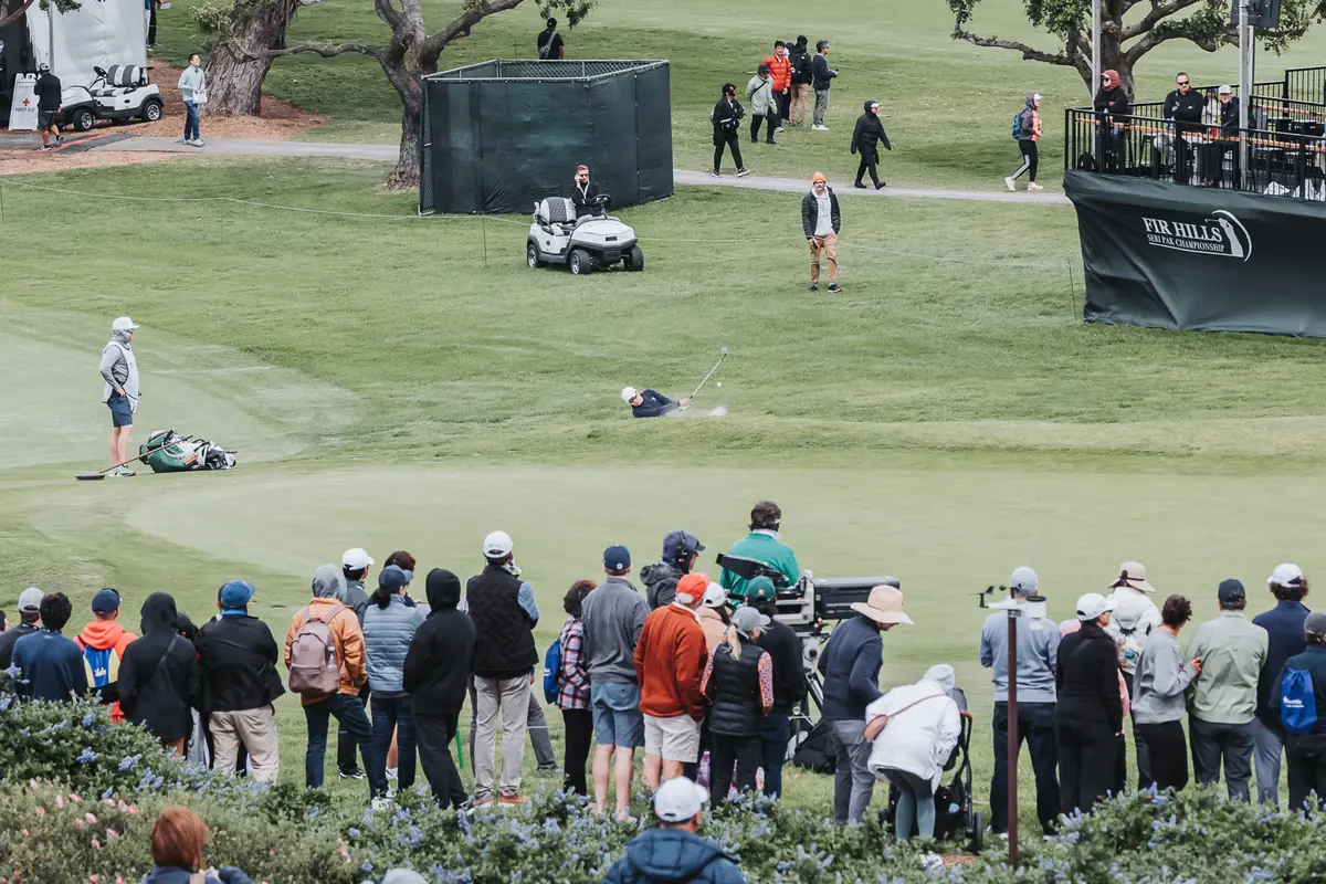 Spectators packed along the ropes around the practice putting green