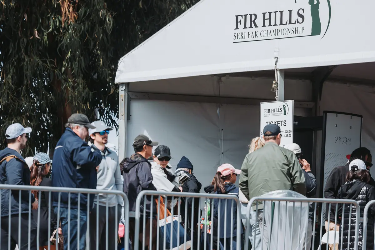 Spectators collecting wristbands at the Fir Hills ticket tent inside the gates