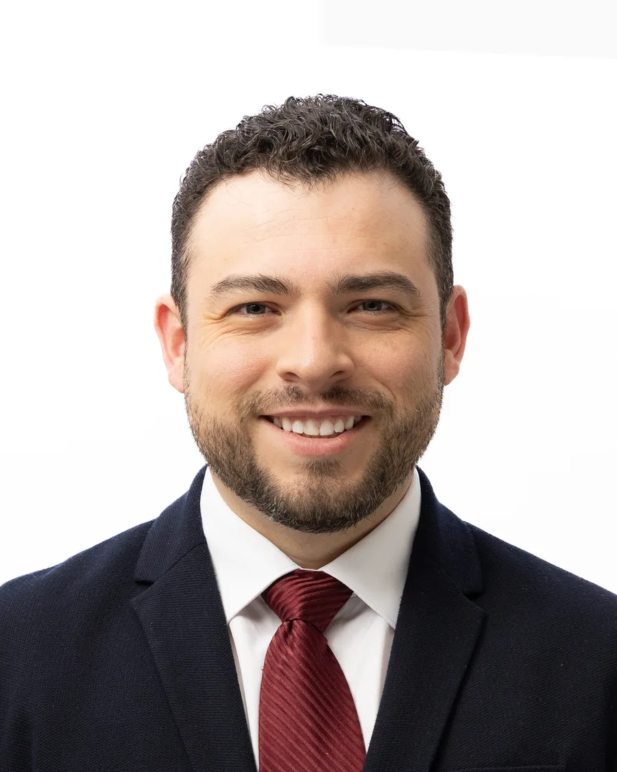 Headshot cropped to a 4:5 portrait for a company website team page