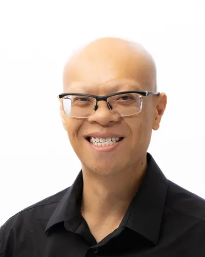 Team member in a black shirt, laughing
