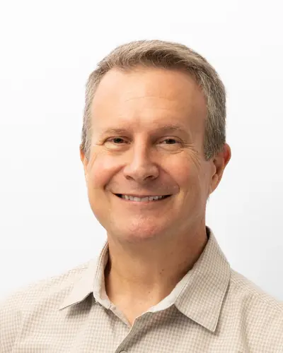 Team member in a stone-coloured shirt