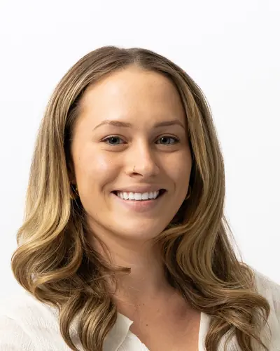 Team member in a cream blouse