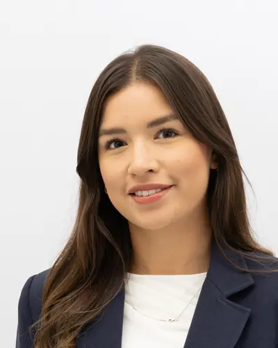 Team member in a navy blazer over a white top