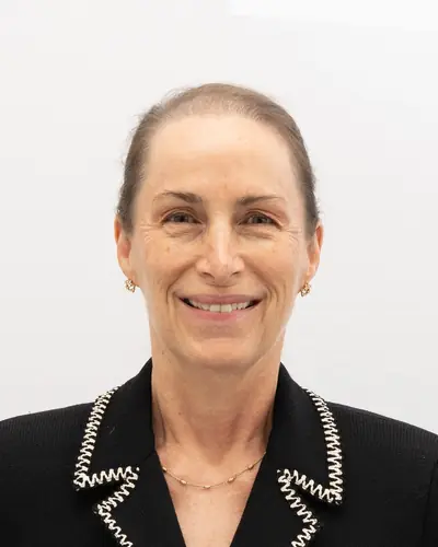 Team member in a black jacket with braided trim