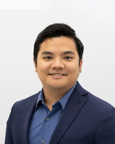 Team member in a navy blazer and blue shirt
