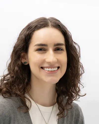 Team member in a grey cardigan