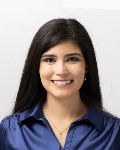 Team member in a royal blue blouse