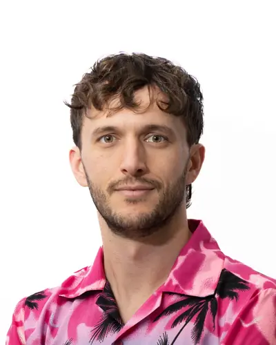 Team member in a patterned pink shirt