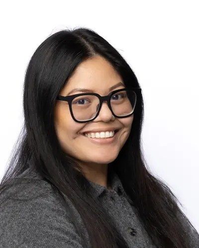 Team member in a grey polo and glasses