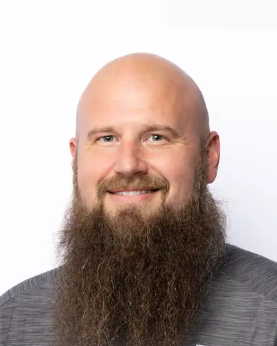 Team member in a grey polo with a company logo