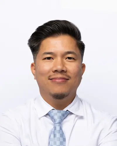 Team member in a white shirt and pale blue tie