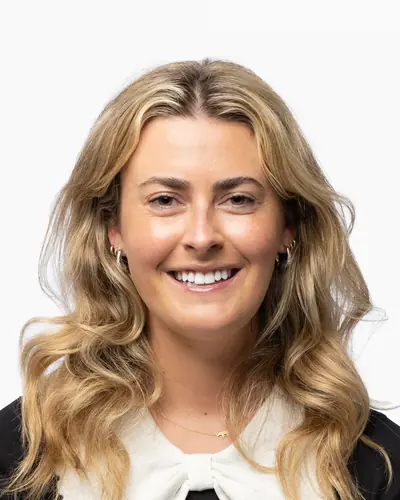 Team member in a black top with a white collar