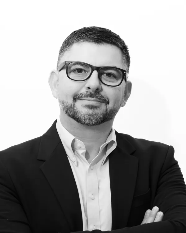 The same executive headshot graded in black and white