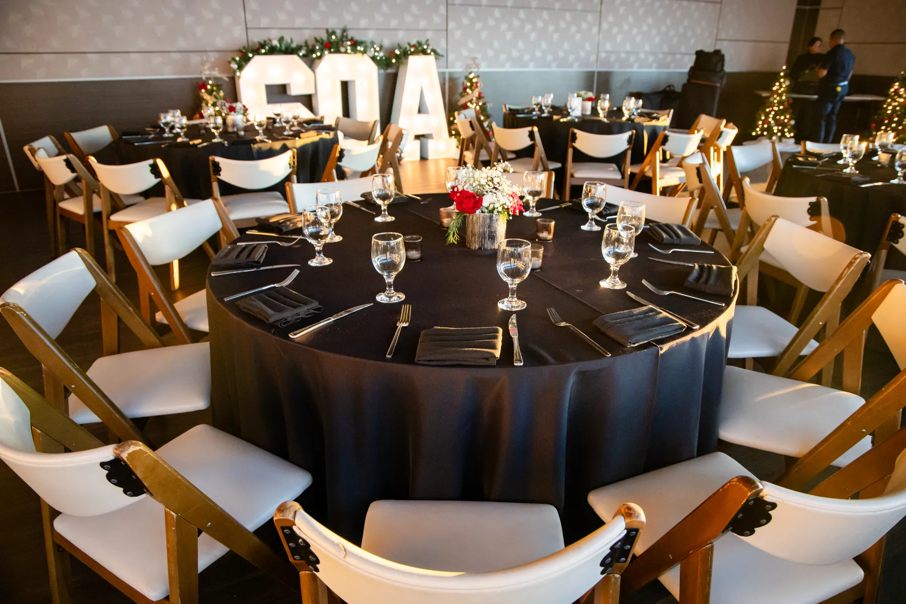 Set tables at Shade Hotel with the illuminated SQA marquee letters in the background