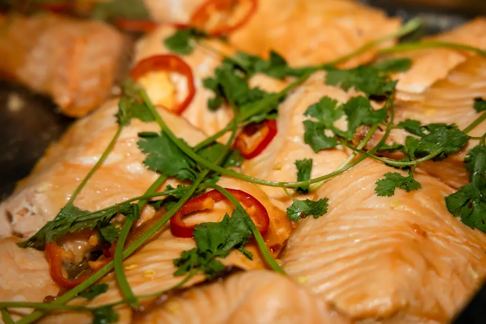 Sliced salmon under coriander and red chilli on the buffet at the SQA Services holiday dinner