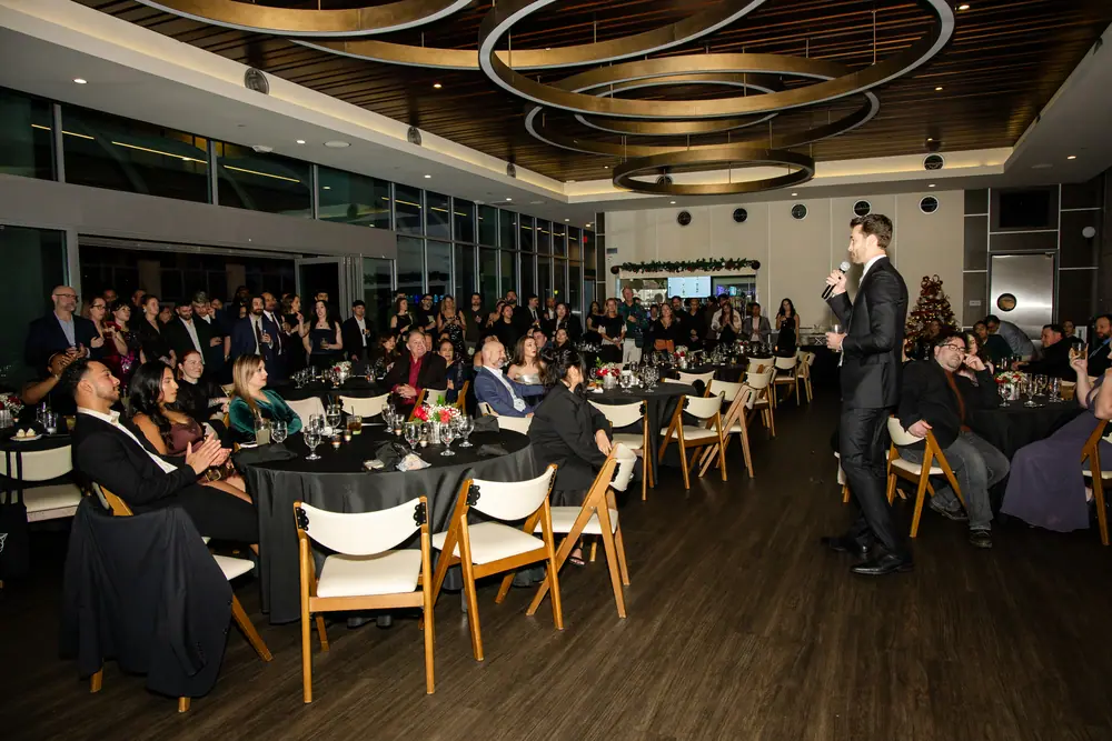The full Sky Level room seated and turned toward the front as the 30th anniversary remarks begin
