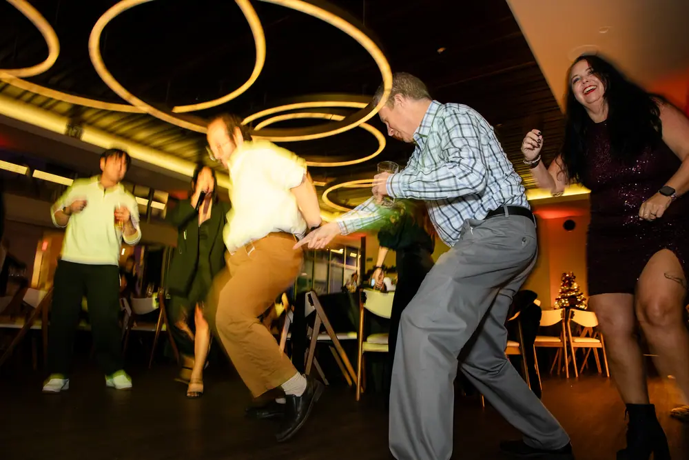 Two guests in mid-stride on the dance floor under the gold ring chandeliers at Shade Hotel Redondo Beach