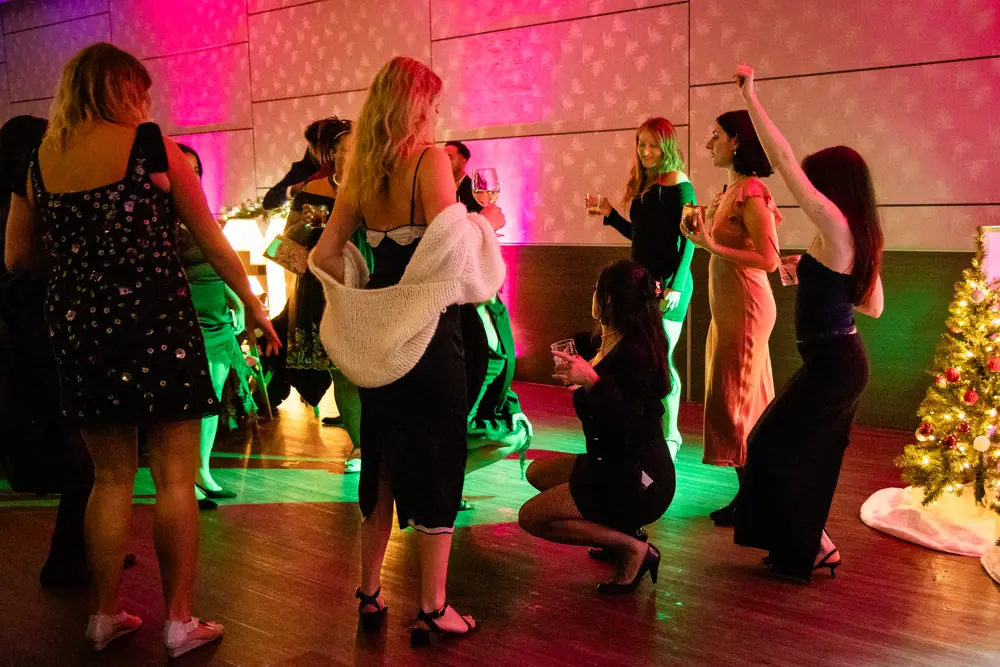 The Sky Level dance floor at capacity under a magenta and green wash